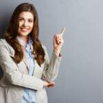 portrait-of-smiling-business-woman-pointing-finger-1