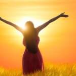 29198626 – young asian woman standing open her arms under the sunrise