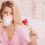 image-woman-romantic-drinking-coffee-holding-a-rose-in-bed